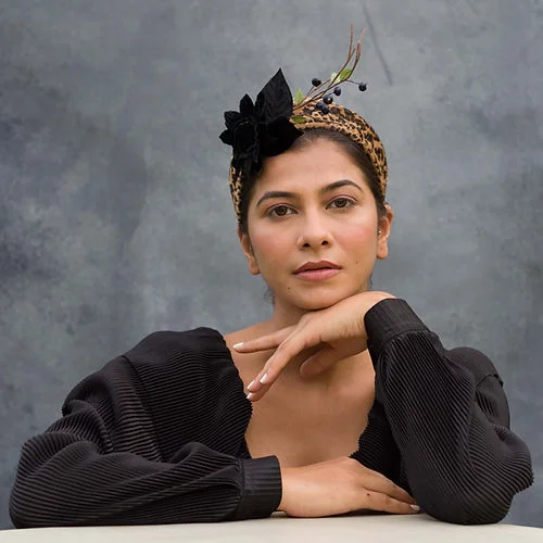 Animal print fascinator with black velvet flower