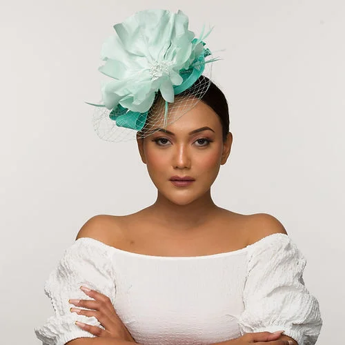 Pale tea green fascinator base with icy blue statement flower